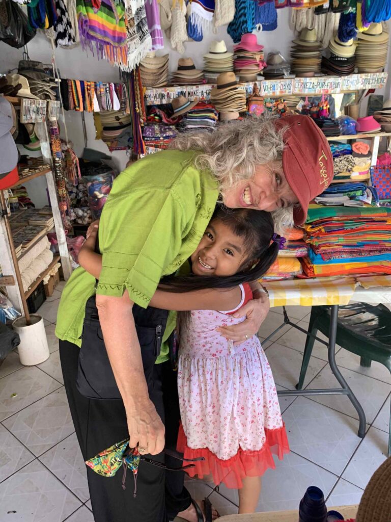 Lee with Genesis, a child she has watched grow up in Barra de Navidad, Mexico